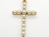 pearl cross pendant on a white background