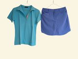 two women ' s skirts hanging on a clothes rack in a room