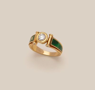 a gold ring with a green enamel band and a diamond