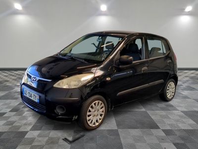 a picture of a small black car on a checkered floor