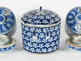 a blue and white container with a lid and two bowls