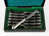 silverware in a green box with a knife in the middle of it