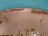 a close up of a blue vase with writing on it