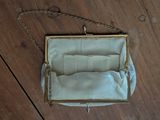 an image of a white purse sitting on top of a wooden floor