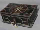 a black and gold box with a gold star on it