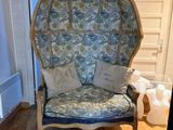 a blue and white chair in a room with wood floors