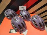 three purple helmets on a table with a price tag on it