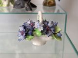 a vase with flowers in it sitting on a glass table