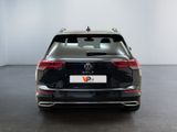 the rear end of a black volkswagen v - cross parked in a white room