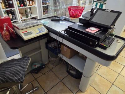 a small desk with a laptop and a printer on it