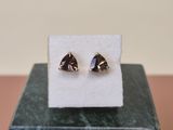 un gros plan sur une paire de boucles d'oreilles posées sur une boîte