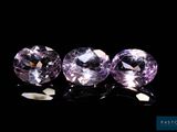 three purple sapphires on a black background
