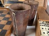 a wooden table with two cups and a checker board