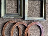 three frames and a pair of wooden rings on a brown carpet