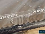 a plastic sign that says playstation on the side of a laptop