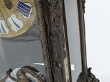 a mirror with a clock on it and a mirror behind it