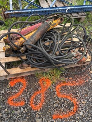 a pile of wires on a pallet next to a tree