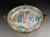 a decorative plate with a painting on it on a table