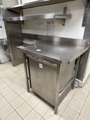 a stainless steel kitchen with a sink and a dishwasher