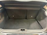 a trunk of a car that is empty with the trunk door open