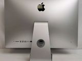 an apple computer sitting on top of a white table