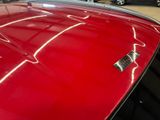 a close up of a red car in a showroom