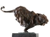 bronze statue of a lion on a marble base on a white background
