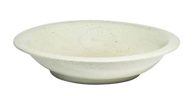 a white bowl sitting on top of a white table