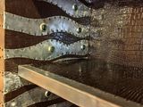 a metal shelf with some metal rivets on it