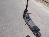 a scooter that is parked on the side of the road