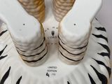 three salt and pepper shakers sitting on top of a plate