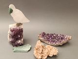 a bird that is standing on a rock next to some crystals