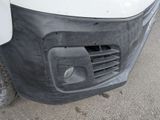a close up of the front bumper of a white van