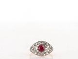 a close up of a diamond and ruby ring on a white surface