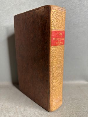 an old book sitting on top of a table next to a wall