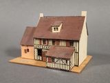 a small model of a house with a brown roof
