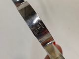 someone is holding a knife in their hand with a red handle
