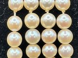 a close up of a bracelet with pearls on it
