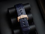 a watch in a black box with a gold clasp