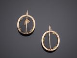 a pair of gold and black earrings with a circular design