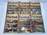 four old comic books are on a white surface