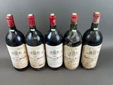 six bottles of wine are lined up in a row on a table