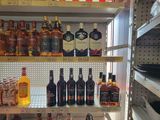 many bottles of liquor on the shelves in the store