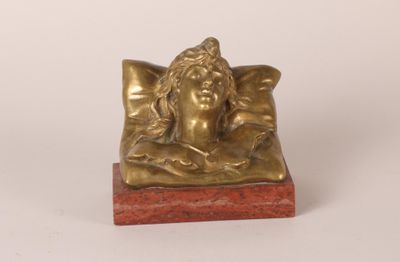 statue of a sleeping woman on a pillow on a marble base