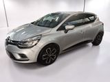 a silver car is parked in a white room with a white floor