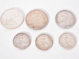 six different types of coins are shown on a white surface