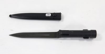 two different types of knives on a white surface