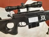the rifle is laying on the bed with the scope attached to it