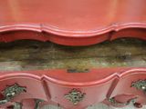 a red table with a drawer on top of it