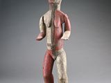 a wooden statue of a man with a long neck and a beard